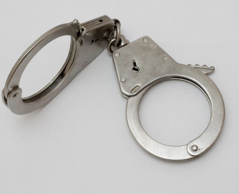 A pair of handcuffs on top of a white table.