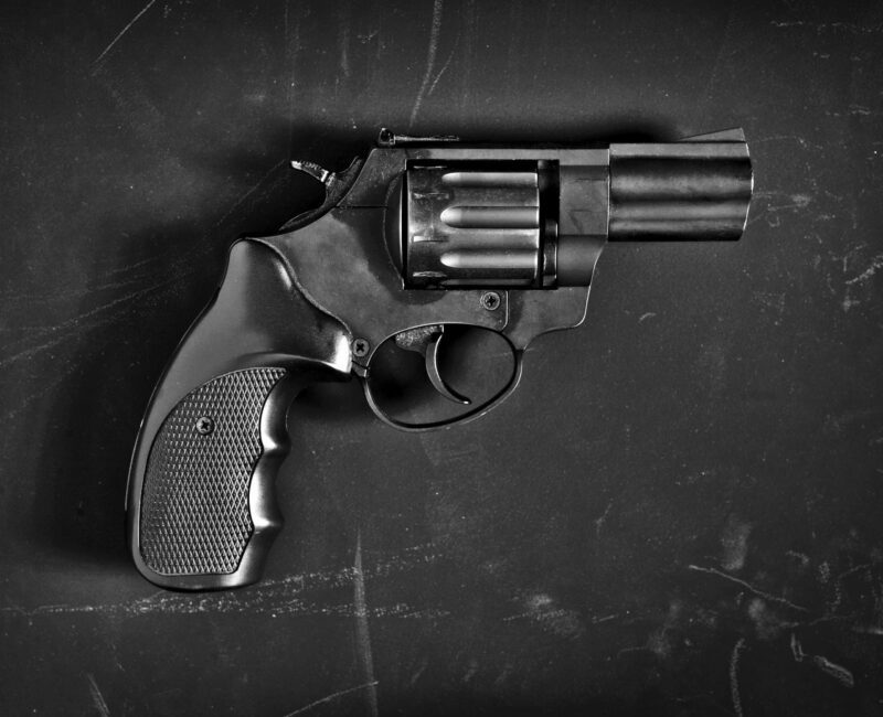 A gun is shown in black and white.