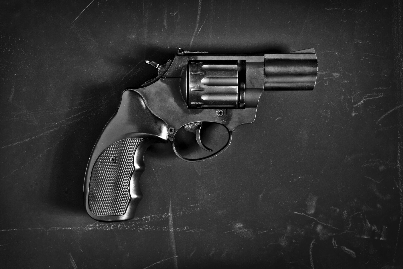 A gun is shown in black and white.